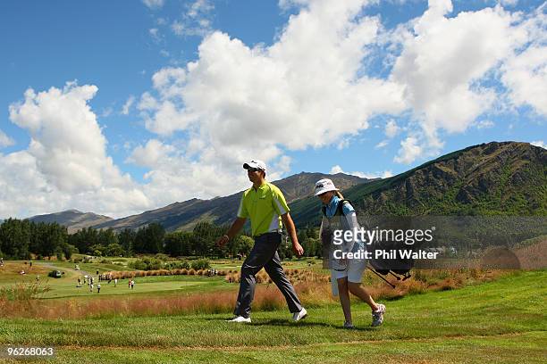Robert Gates and his caddy Lauren Johnson walk down the 2nd fairway during day three of the New Zealand Open at The Hills Golf Club on January 30,...