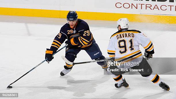 Jason Pominville of the Buffalo Sabres dekes around Marc Savard of the Boston Bruins at HSBC Arena on January 29, 2010 in Buffalo, New York.