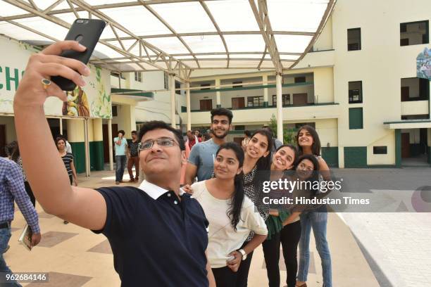 Meritorious students of St Josephs Co-Ed school celebrate their success in CBSE class12th exam results, on May 26, 2018 in Bhopal, India. A total of...