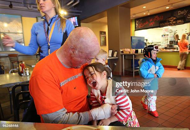 Wounded U.S. Marine Capt. Ryan Voltin hugs his daughter Maya while taking a break from snowboarding on January 28, 2010 in Vail, Colorado. As a Cobra...