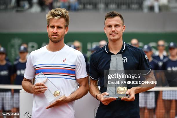 Hungarian tennis player Marton Fucsovics poses with German tennis player Peter Gojowczyk after winning the final game at the Geneva Open ATP 250...