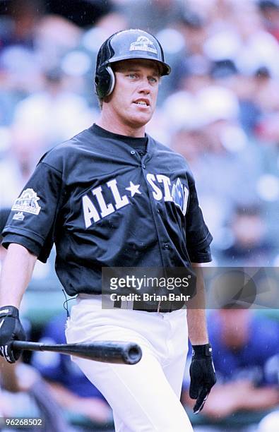 John Elway swings at the pitch during the batting practice before the 1998 All Star Celebrity Home Run Derby at Coors Field on July 6,1998 in...