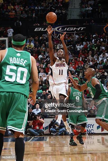 Jamal Crawford of the Atlanta Hawks shoots a half-court buzzer beater at the end of the first period against the Boston Celtics on January 29, 2010...