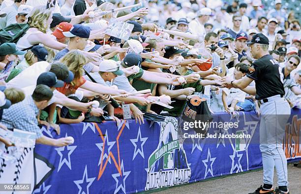 Cal Ripken Jr. Of the American League signs autographs for fans during the MLB All-Star Game at Coors Field on July 7, 1998 in Denver, Colorado. The...