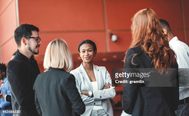 standing group of business people in the office, coffee break - lobbying stock pictures, royalty-free photos & images