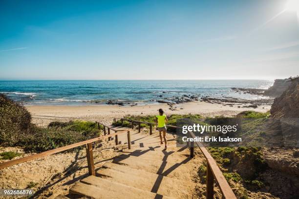 usa, california, newport beach, woman running down stairs - newport beach stock-fotos und bilder