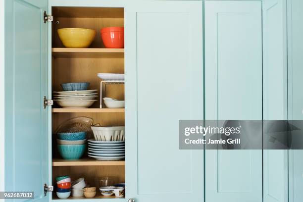 dishes in cupboard - cabinet bildbanksfoton och bilder