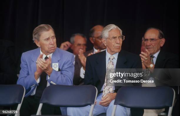 Pee Wee Reece, Phil Rizzuto and Yogi Berra clap during the 1997 Hall of Fame Induction Ceremony at Clark Sports Center on August 3.1997 in...