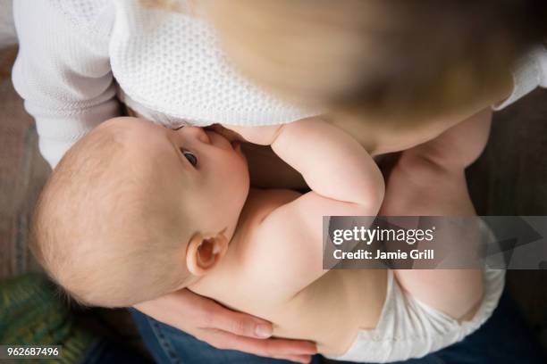 mother breast feeding baby girl (12-17 months) - 12 17 months stock pictures, royalty-free photos & images