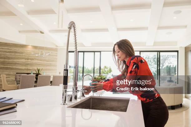 woman washing dishes in kitchen - huge task stock pictures, royalty-free photos & images