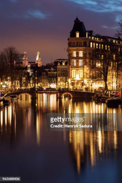 netherlands, amsterdam, bascule bridge over canal at night - bascule bridge stock pictures, royalty-free photos & images