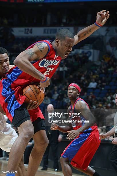 Ramon Sessions of the Minnesota Timberwolves goes for the ball between the legs of Marcus Camby of the Los Angeles Clippers during the game on...