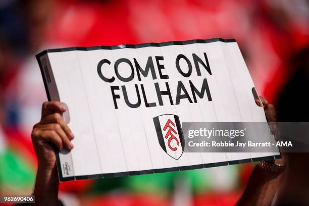 Fan of Fulham holds up a clapper which reads Come On Fulham prior to the Sky Bet Championship Play Off Final between Aston Villa and Fulham at...