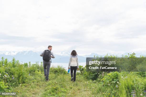 young couple hiking in alaska - homer alaska stock pictures, royalty-free photos & images