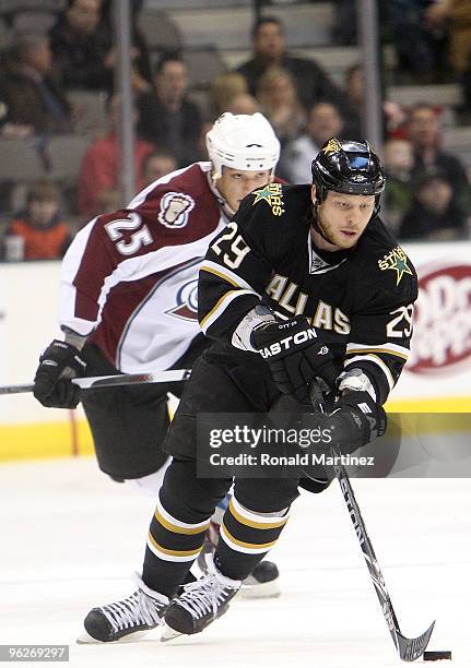 Left wing Steve Ott of the Dallas Stars skates the puck past Chris Stewart of the Colorado Avalanche in the first period on January 29, 2010 in...