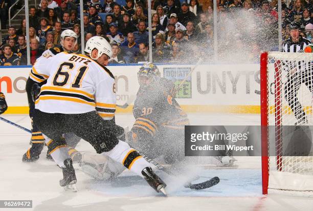 Ryan Miller of the Buffalo Sabres peers through the flying snow to make a second period save against Byron Bitz of the Boston Bruins on January 29,...