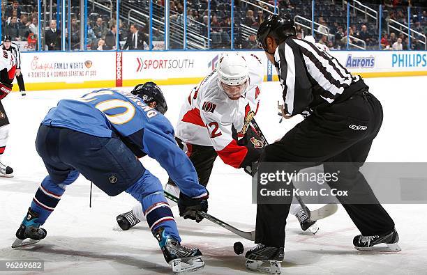 Mike Fisher of the Ottawa Senators against Colby Armstrong of the Atlanta Thrashers at Philips Arena on January 12, 2010 in Atlanta, Georgia.