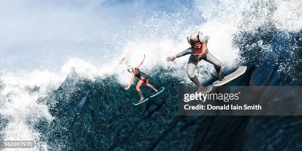 futuristic female surfers using hover boards to surf down large waves - hoverboard water stock pictures, royalty-free photos & images