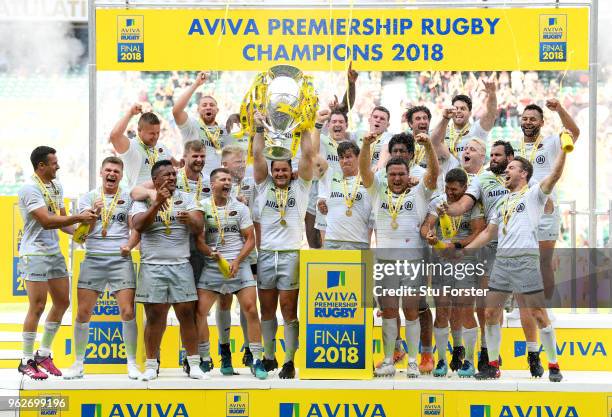 Brad Barritt of Saracens lifts the Aviva Premiership trophy following his side's victory during the Aviva Premiership Final between Saracens and...