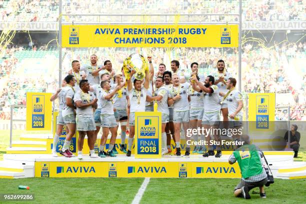 Brad Barritt of Saracens lifts the Aviva Premiership trophy following his side's victory during the Aviva Premiership Final between Saracens and...