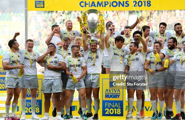 Brad Barritt of Saracens lifts the Aviva Premiership trophy following his side's victory during the Aviva Premiership Final between Saracens and...