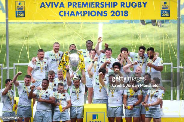 Brad Barritt of Saracens lifts the Aviva Premiership trophy following his side's victory during the Aviva Premiership Final between Saracens and...