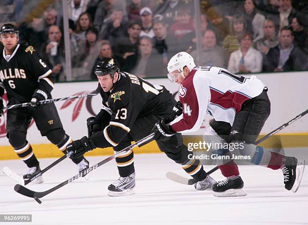 Krys Barch of the Dallas Stars tries to keep the puck away against John-Michael Liles of the Colorado Avalanche on January 29, 2010 at the American...