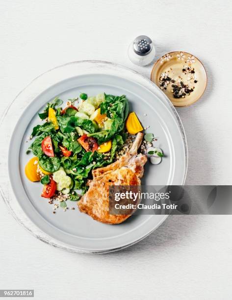 roasted pork chop with salad - paleo diet stock pictures, royalty-free photos & images