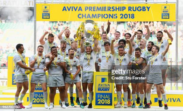 Saracens captain Brad Barritt lifts the trophy as his team mates celebrate after the Aviva Premiership Final between Exeter Chiefs and Saracens at...