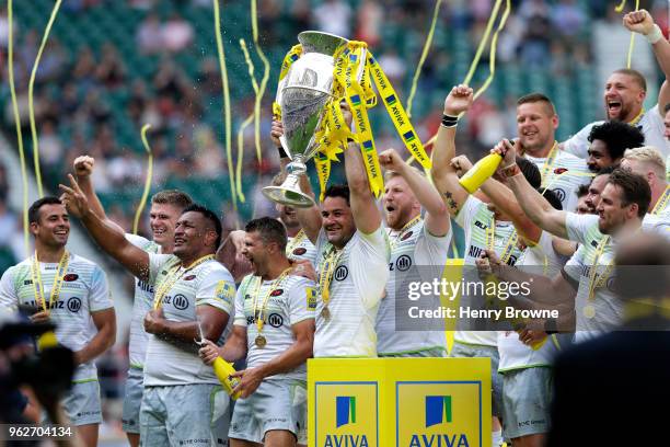 Brad Barritt of Saracens lifts the Aviva Premiership trophy following his side's victory during the Aviva Premiership Final between Saracens and...