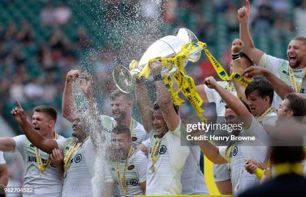 Brad Barritt of Saracens lifts the Aviva Premiership trophy following his side's victory during the Aviva Premiership Final between Saracens and...