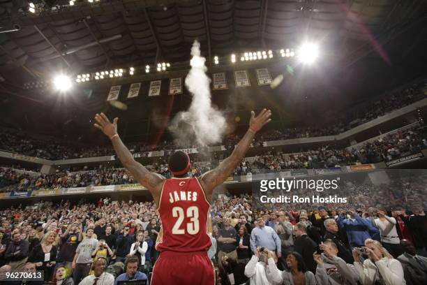 LeBron James of the Cleveland Cavaliers performs his pregame ritual of throwing talcum powder into the air prior to the game against the Indiana...