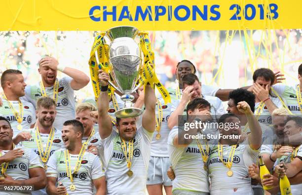 Saracens captain Brad Barritt lifts the trophy as his team mates celebrate after the Aviva Premiership Final between Exeter Chiefs and Saracens at...