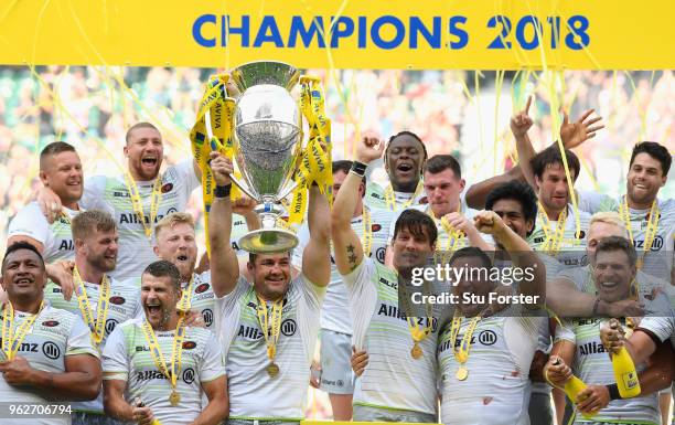 Saracens captain Brad Barritt lifts the trophy as his team mates celebrate after the Aviva Premiership Final between Exeter Chiefs and Saracens at...