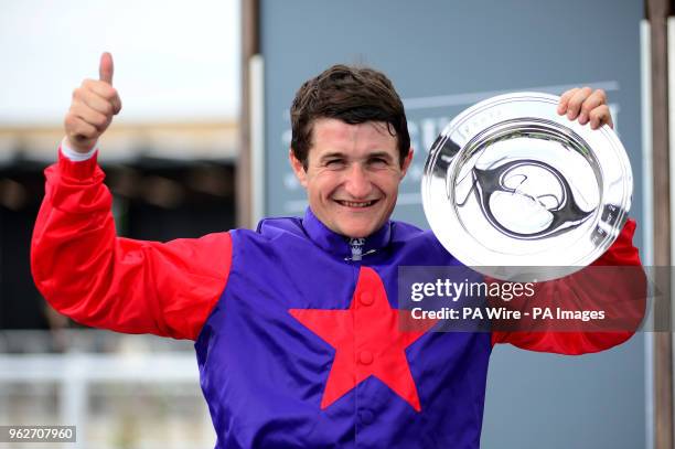 Jockey Shane Foley poses with the trophy after Romanised won the Tattersalls Irish 2000 Guineas during day one of the 2018 Tattersalls Irish Guineas...