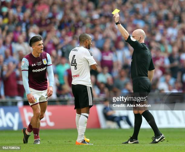 Denis Odoi of Fulham is shown a yellow card by referee Anthony Taylor during the Sky Bet Championship Play Off Final between Aston Villa and Fulham...