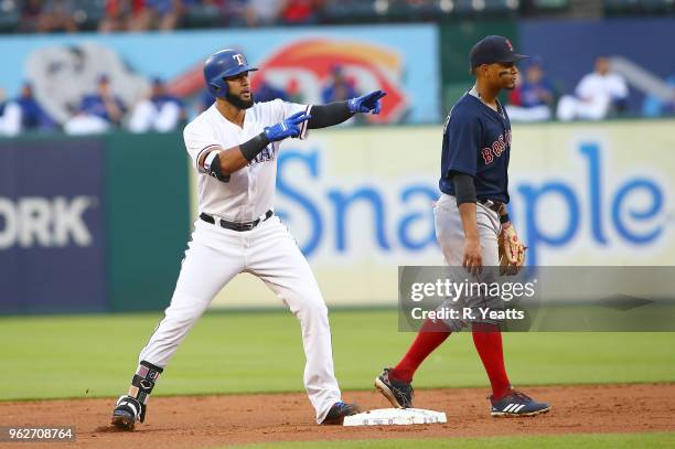 Eduardo Nunez of the Boston Red Sox looks on as Nomar Mazara of the Texas Rangers points to the dugout after hitting double in the second inning at...