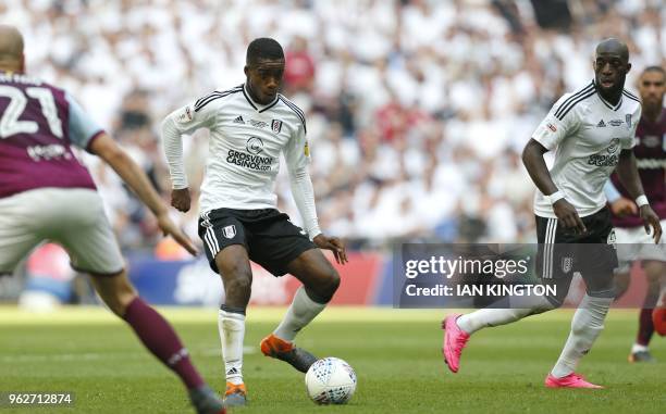 Fulham's English defender Ryan Sessegnon makes a through pass in the build up to the opening goal by Fulham's English midfielder Tom Cairney during...