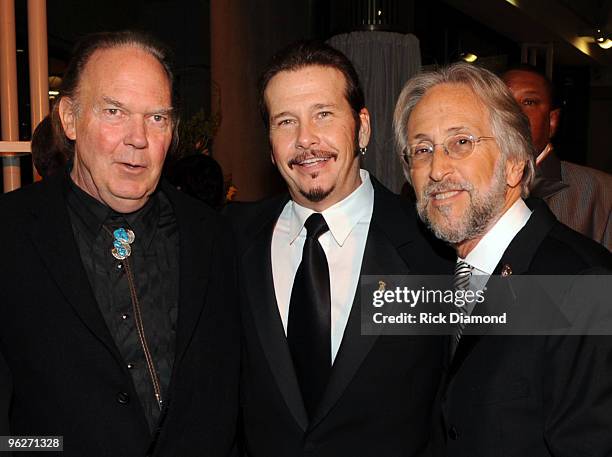 MusiCares Person of the Year musician Neil Young, Recording Academy Chair of the Board of Trustees George Flanigen and President of the National...