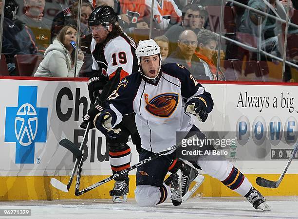Chris Thorburn of the Atlanta Thrashers is checked by Scott Hartnell of The Philadelphia Flyers during their game on January 28, 2010 at The Wachovia...