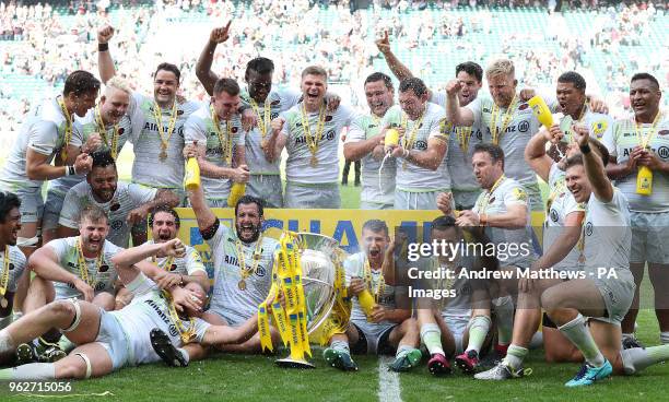 The Saracens players celebrate with the trophy after they win the Aviva Premiership Final at Twickenham Stadium, London.