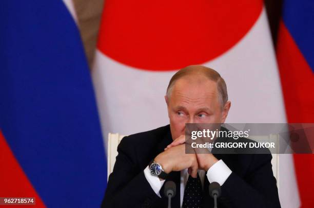 Russian President Vladimir Putin attends a joint news conference with Japanese Prime Minister Shinzo Abe following their meeting at the Kremlin in...