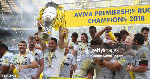 Brad Barritt, captain of Saracens raises the trophy after their victory during the Aviva Premiership Final between Exeter Chiefs and Saracens at...