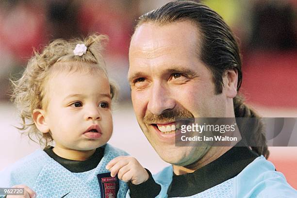 David Seaman of Arsenal poses with his youngest child during the David Seaman Testimonial match against Barcelona played at Highbury, in London....