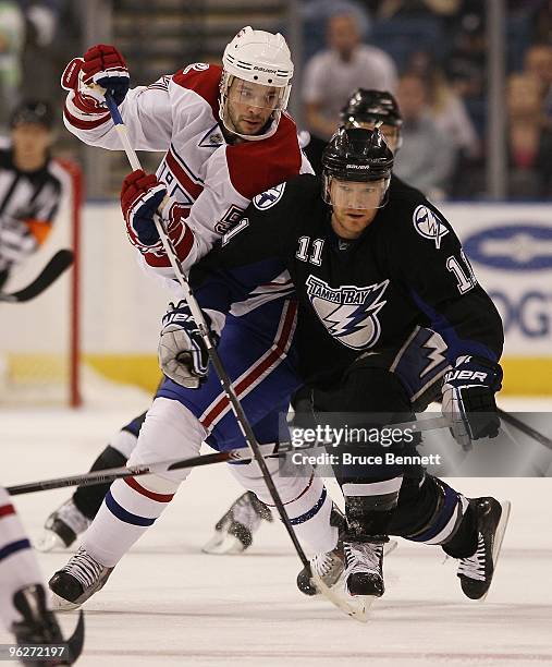 Benoit Pouliot of the Montreal Canadiens and Jeff Halpern of the Tampa Bay Lightning jostle for position at the St. Pete Times Forum on January 27,...