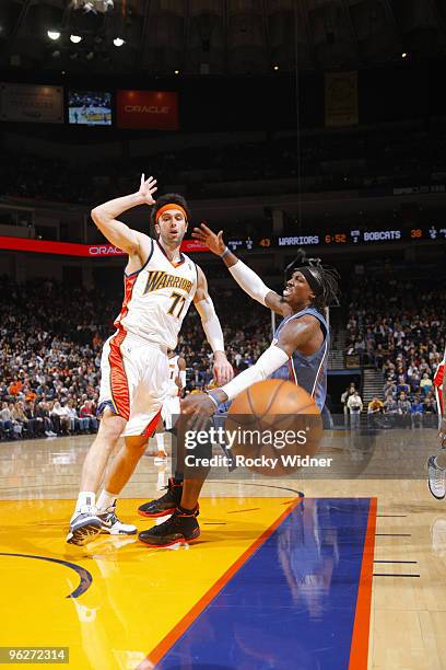 Vladimir Radmanovic of the Golden State Warriors collides with Gerald Wallace of the Charlotte Bobcats on January 29, 2010 at Oracle Arena in...