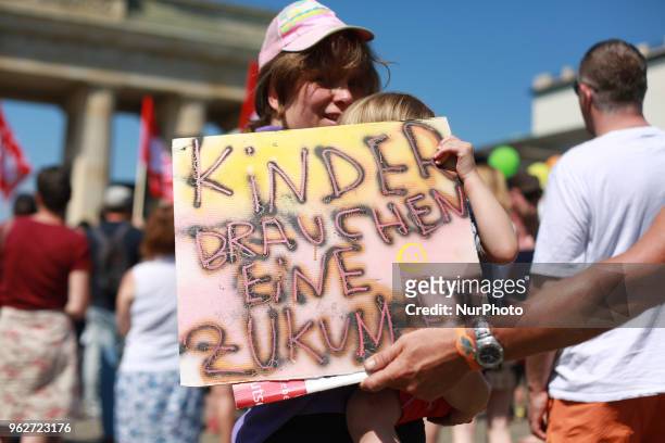 Demonstrants hold a banner that reads ' KInder Brauchen Eine Zukunft - Kids Need A future' during a gathering to protest agains the recent Kita...