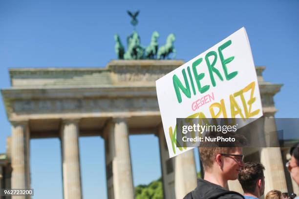 Demonstrants hold a banner that reads ' Niere Gegen Kitaplatz - Kidney Agains Childcare place' during a gathering to protest agains the recent Kita...