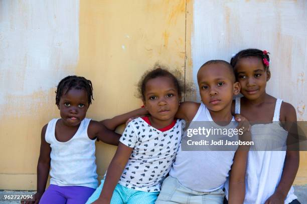 four young jamaican village children - jamaican girl stock pictures, royalty-free photos & images