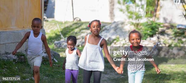 jamaican children playing outside in a poor village. - jamaican girl stock pictures, royalty-free photos & images